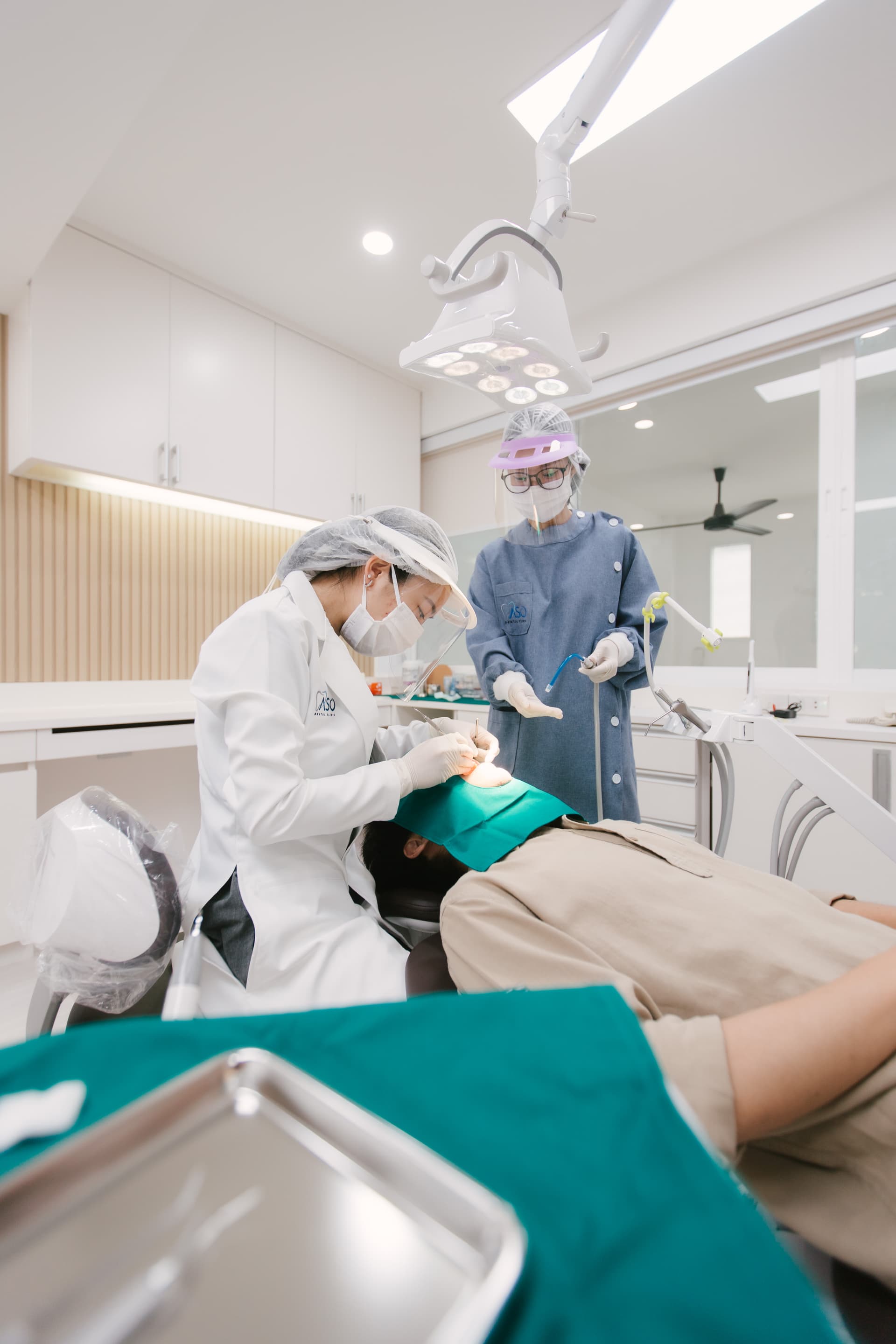 Dentist performing procedure with rubber dam